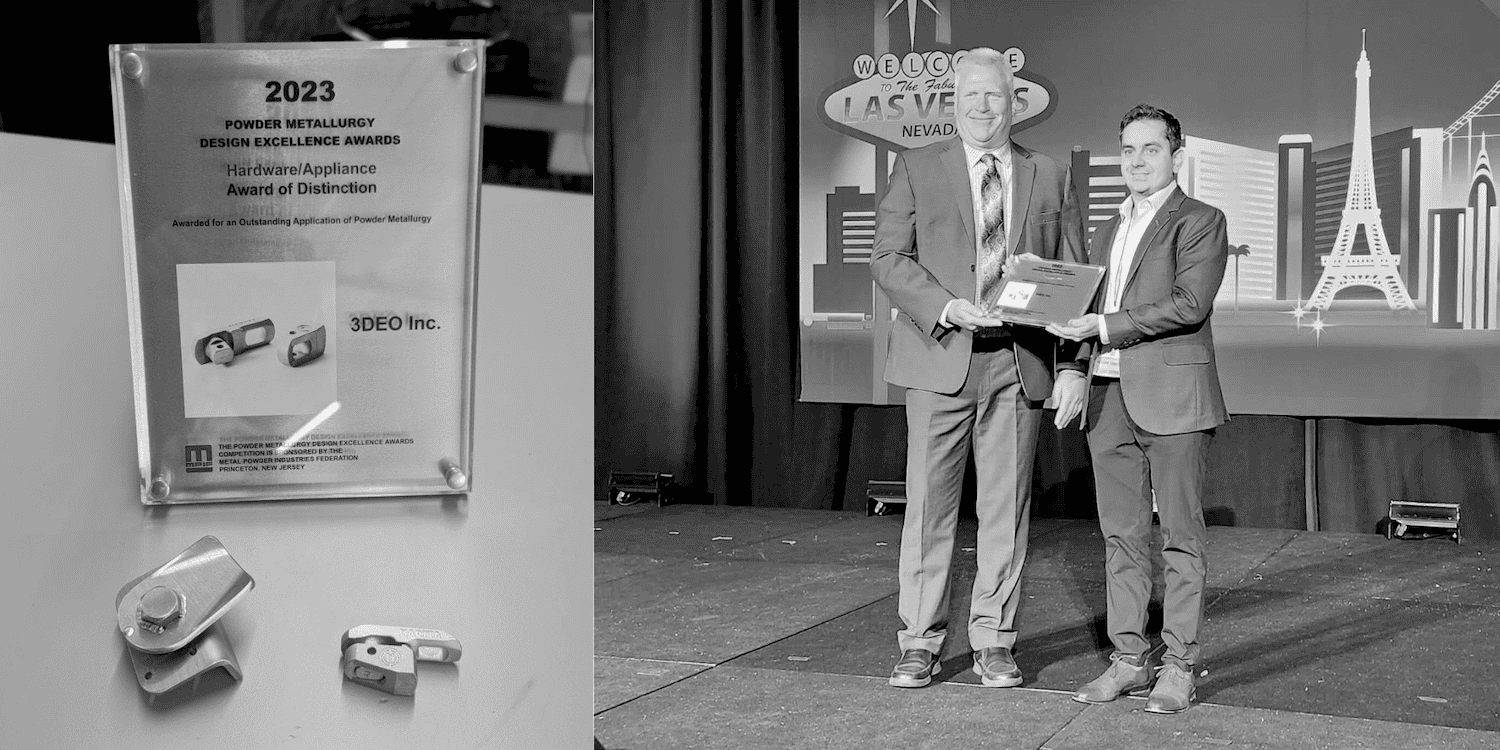 3DEO Wins Grand Prize at 2023 Design Excellence Awards Black and white image of two men on stage at an award event in Las Vegas. One is handing a plaque to the other. A close-up of the award plaque and a small part is shown on the left.