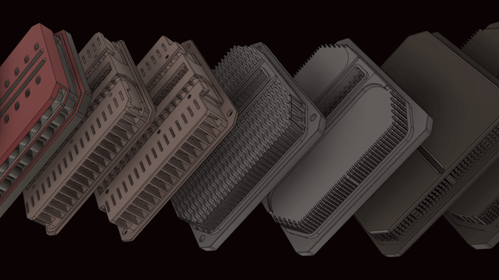 A row of metallic heat sinks with varying fin designs and colors is displayed against a black background, showcasing innovative heat sink technology.